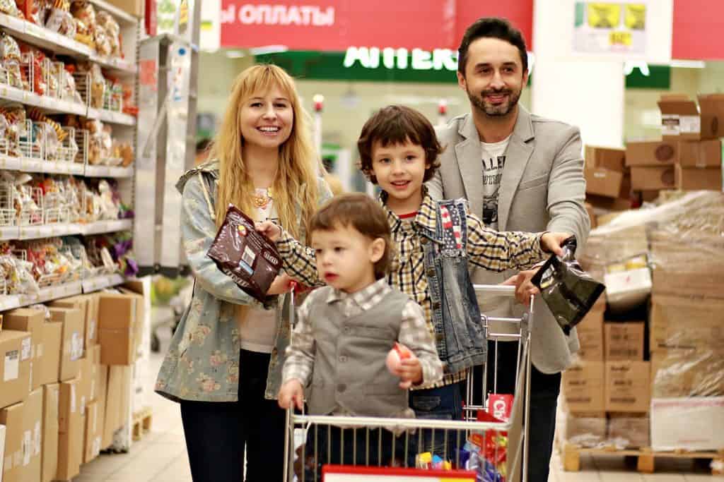 Happy family shopping at grocery store.
