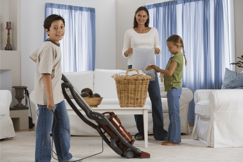 Image of mom and kids doing chores as part of a back-to-school routine.