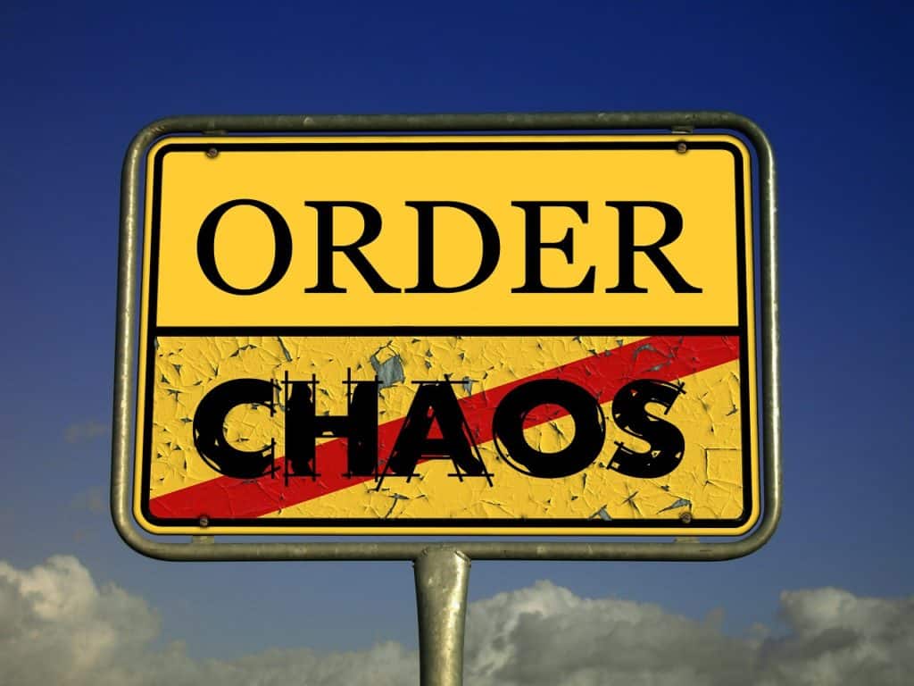 Image of road sign showing the word order over the word chaos. Chaos is crossed out.