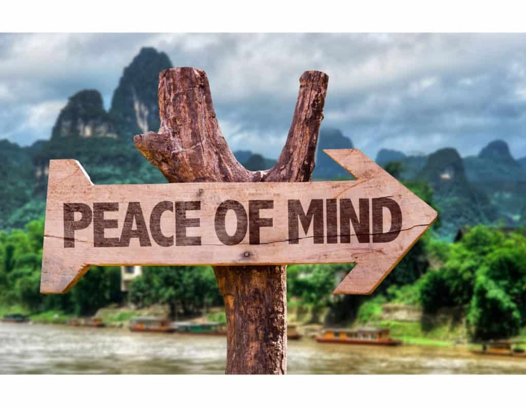 Image of wooden arrow sign on which is engraved "Peace of Mind."