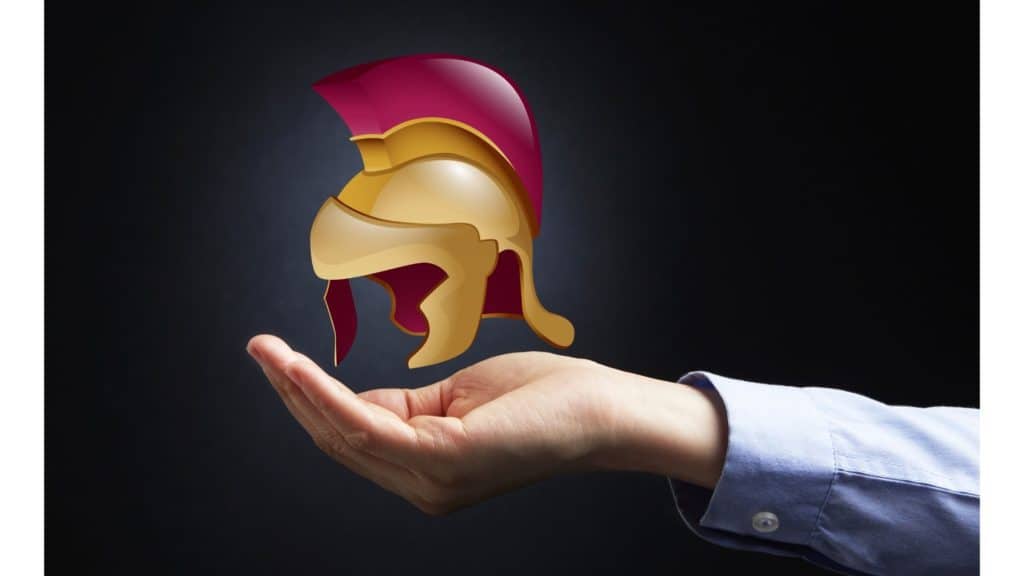 Image of a hand holding a floating cartoon helmet.