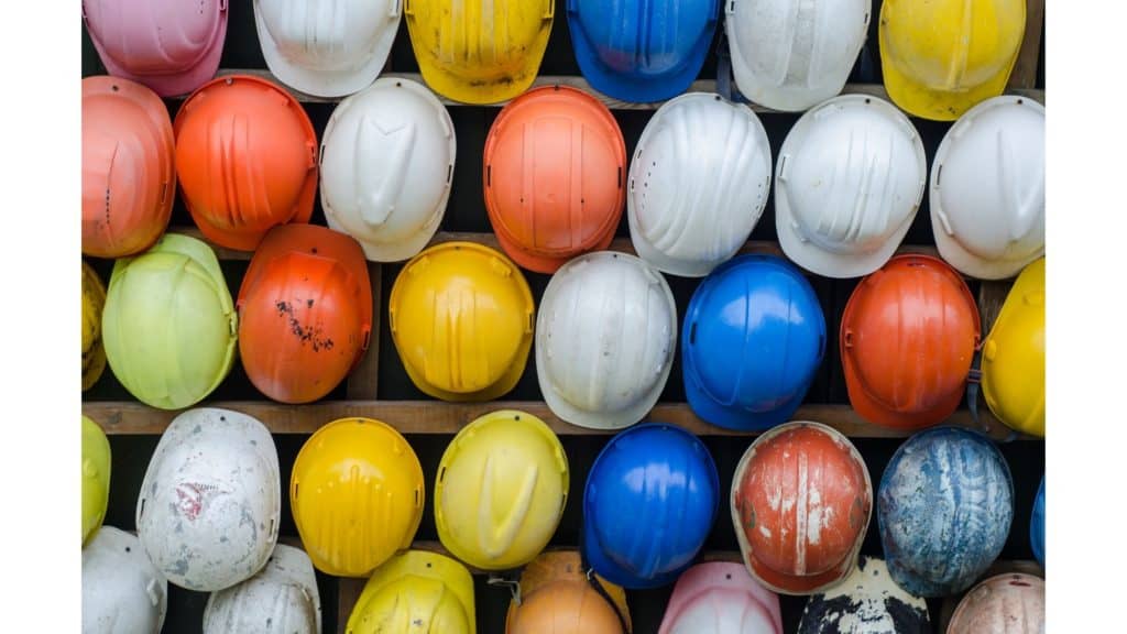 Image of colorful helmets hanging on racks.