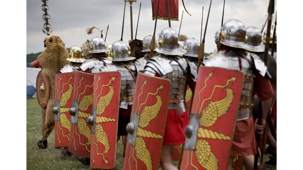 Soldiers carrying large shields.