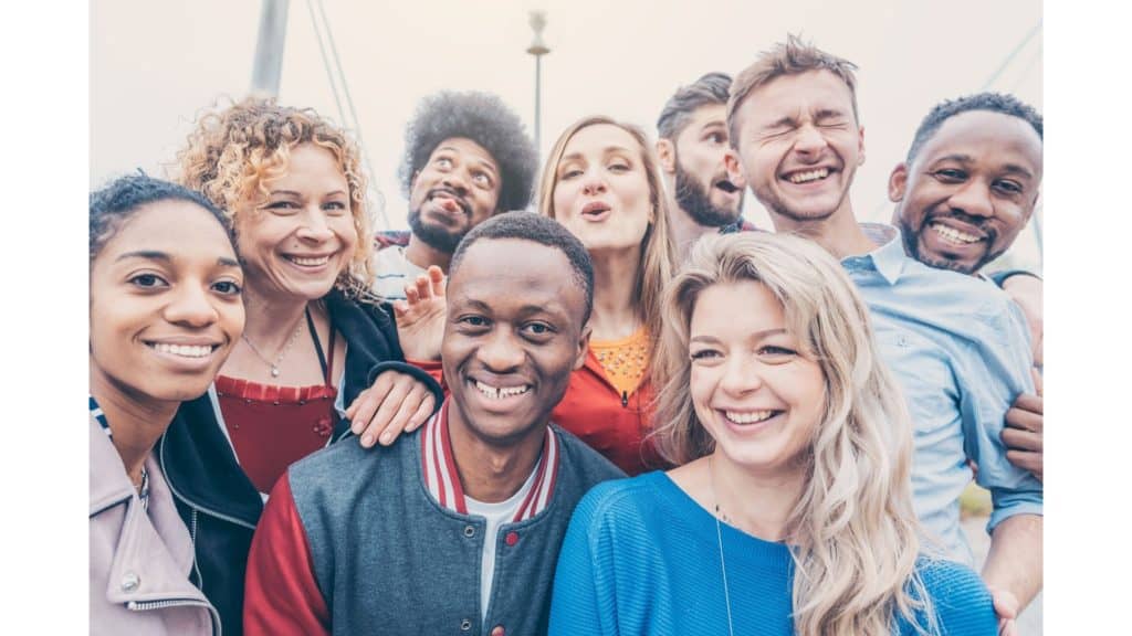 This image of a diverse group of people smiling reflects that anyone can accept the gift of salvation through Jesus Christ.