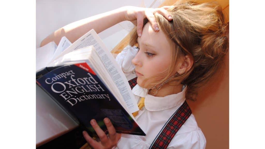 Girl reading the "Compact Oxford English Dictionary."