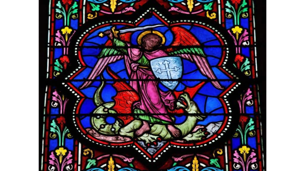 Stained glass depiction of an angel of the Lord defeating the dragon, or the devil.