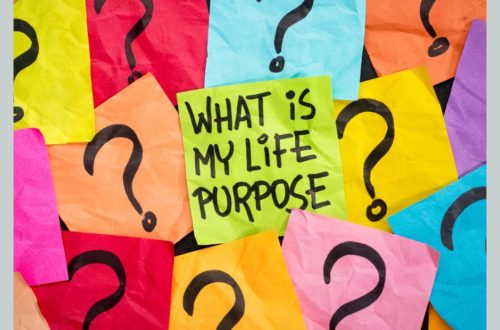 "What is my life purpose?" written on a sticky note surrounded by sticky notes with question marks on them.