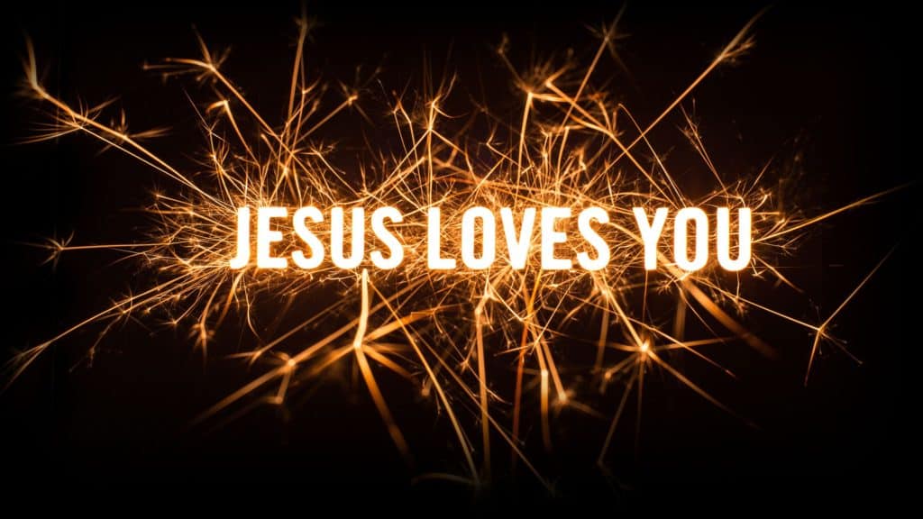 The words "Jesus loves you" in white capital letters with sparks around them.