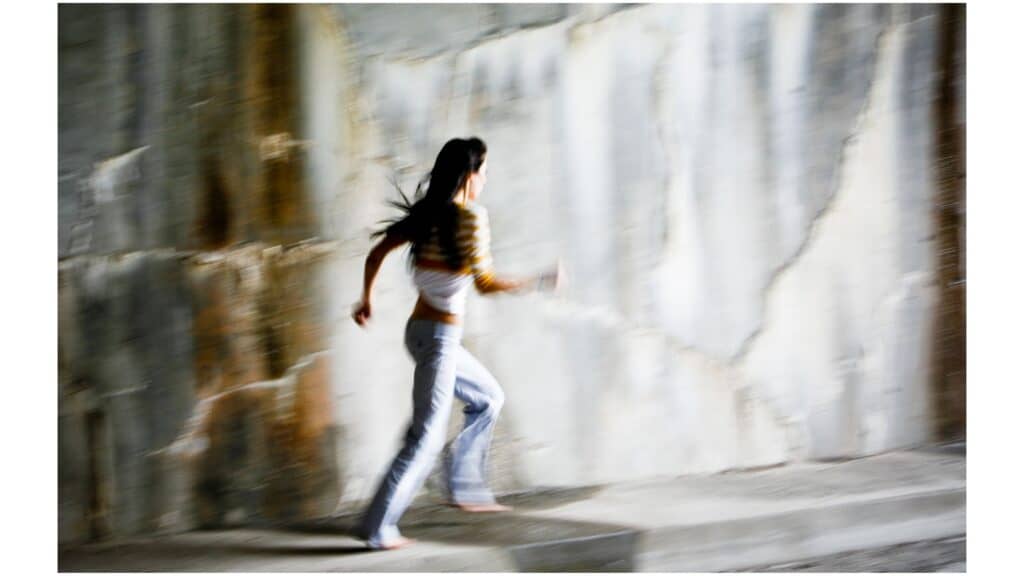 Image of woman running away. God loves us even when we run away from Him.