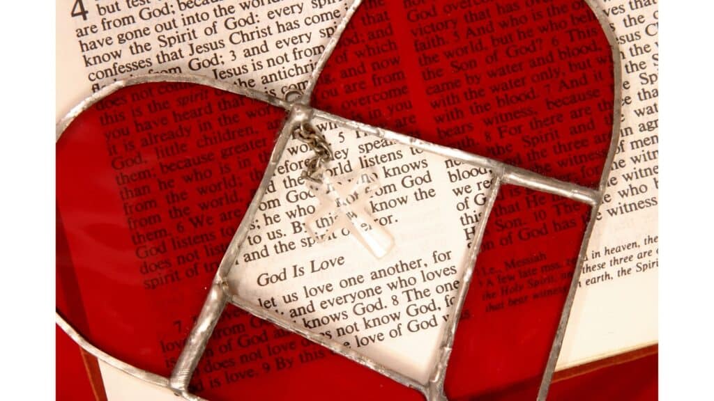 Image of stained glass heart over scripture that says "God is love."