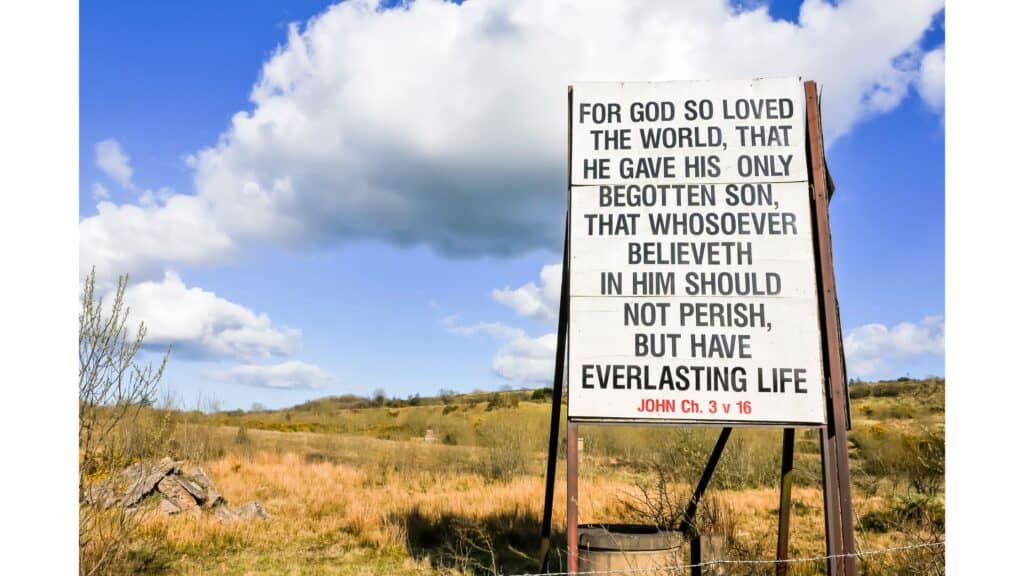 John 3:16 image - "For God so loved the world that He gave His only begotten son that whosoever believeth in Him should not perish, but have everlasting life." written on a sandwich board and placed in the desert.